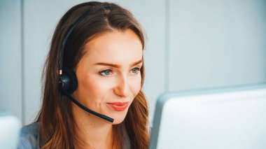 Business people wearing headset working in office to support remote customer or colleague. Call center, telemarketing, customer support agent provide service on telephone video conference call. Jivy clipart