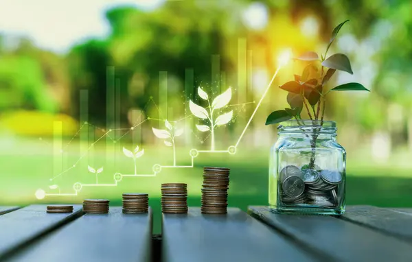 Growing coin stack and tree planted inside money saving jar with ESG business investment with sustainable growth potential lead to profitable financial return and environmental protection. Reliance