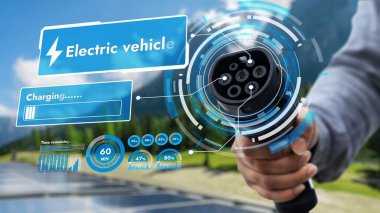 Kamera önündeki EV şarj aletine odaklan. Çevre dostu, bulanık, doğal arka planı olan bir hologram. Alternatif temiz enerji kullanarak CO2 emisyonunu azaltan EV araba şarj prizi.