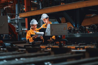 Profesyonel kalite kontrol müfettişi çelik makineleri ve üretim süreci üzerinde güvenlik denetimi yapıyor. Fabrika mühendisi veya operatör ağır sanayi tesislerinde optimizasyon yapıyor. Örnek gösteriliyor