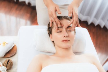 Kafkasyalı kadın stres önleyici kafa masajından ve lüks tatil beldesi ya da otel spa salonundaki modern ışık ortamında yüz güzelliği eğlencelerini şımartmaktan hoşlanıyor. Sessiz.