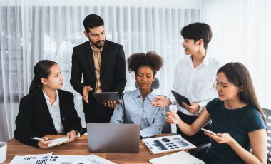 Mutlu iş adamları birlikte çalışır, şirket ofisinde tartışırlar. Profesyonel ve çeşitlilik takım çalışması iş planını bilgisayarda tartışır. Modern çok kültürlü ofis çalışanı. Uyum