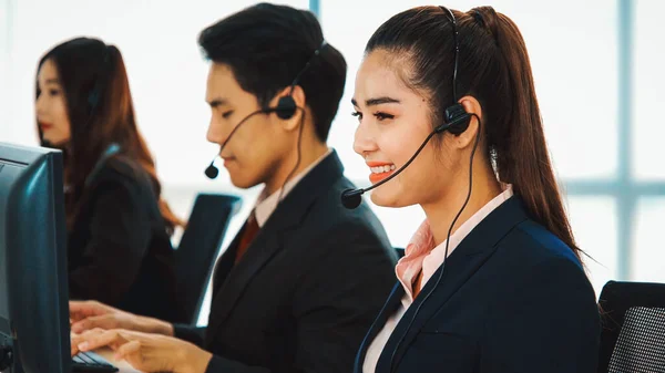 Business people wearing headset working in office to support remote customer or colleague. Call center, telemarketing, customer support agent provide service on telephone video conference call. Jivy