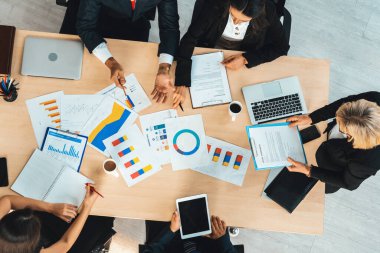 İş adamları grup toplantısı ofiste yukarıdan çekildi. İş kadınları, iş adamları ve ofis çalışanları toplantı masasında proje planlama belgeleriyle takım konferansında çalışıyorlar. Jivy