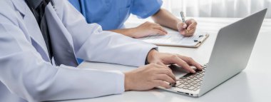 Hastane masasında birlikte çalışan ve tıbbi tedavi planlayan profesyonel tıbbi ekip. Takım çalışması başarılı hastalıklara ve hastalıklara yol açar. Panorama Katı