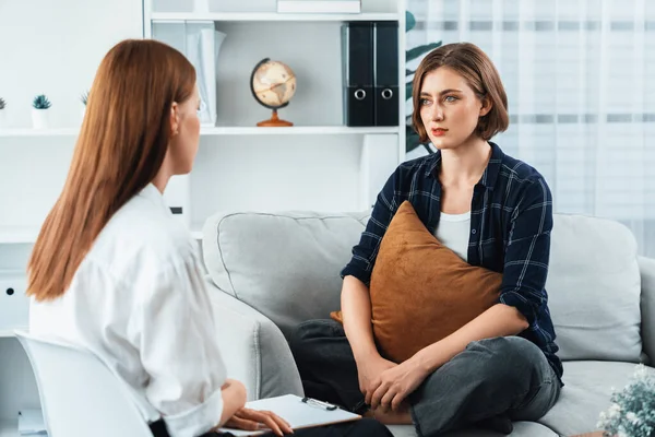 Happy patient and psychologist have mental health conversation in clinic with positive emotion while explaining utmost successful work and life to psychologist in home office .