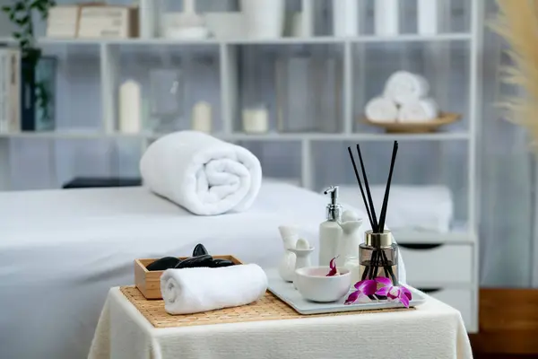 Exquisite display of beauty treatment and spa salon accessories arranged on spa table in luxury spa resort. Relaxing spa massage and recreation background concept. Quiescent