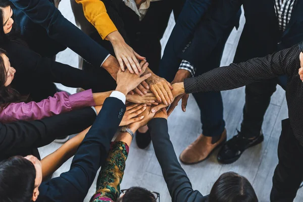 A group of diversity people putting their hands together. Showing unity teamwork and friendship. Close up top view of young business man and business woman joining as a team. Intellectual.