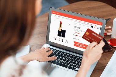İnternet pazarından alışveriş yapan kadın modern yaşam tarzı için satış malzemeleri arıyor ve son derece siber güvenlik yazılımı tarafından korunan cüzdandan çevrimiçi ödeme için kredi kartı kullanıyor