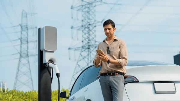 Man Pay Electricity Smartphone While Recharge Car Battery Charging Station — Stock Photo, Image