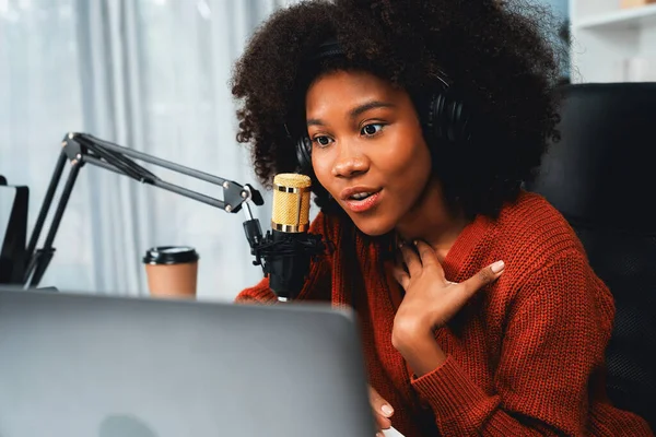Host channel of beautiful African woman influencer talking with new listeners in broadcast studio. Time slot of life coach consultant on live social media online. Concept of giving advice. Tastemaker.