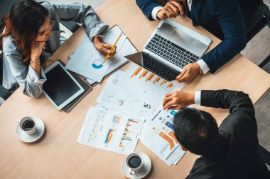 İş adamları grup toplantısı ofiste yukarıdan çekildi. İş kadınları, iş adamları ve ofis çalışanları toplantı masasında proje planlama belgeleriyle takım konferansında çalışıyorlar. Jivy
