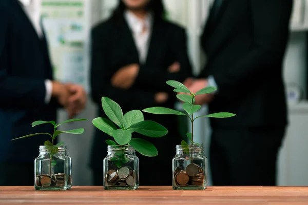 Organic money growth investment concept shown by money savings in glass jar. Financial investments rooted and cultivating wealth in harmony with nature. Quaint
