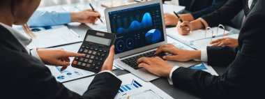 İş zekası ve veri analizi kavramı. Analizci ekibi laptop ekranında finansal veri analizi üzerinde çalışıyor. Etkili iş stratejik planlama için pazarlama göstergesi olarak. İçgörü