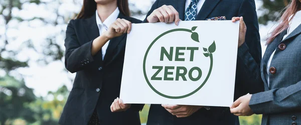 Group of business people stand united, holding eco-friendly idea and concept for environmental awareness campaign by business corporate to embrace net zero emission and environmental friendly. Gyre