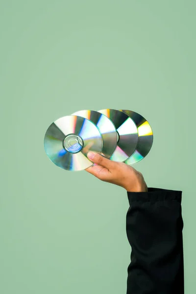 Businessmans hand holding electric CD on isolated background. Eco-business recycle waste policy in corporate responsibility. Reuse, reduce and recycle for sustainability environment. Quaint