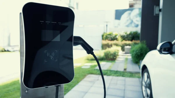 Home charging station provides an eco-friendly sustainable power supply for EV cars. Progressive concept for future green energy storage for electric vehicles.