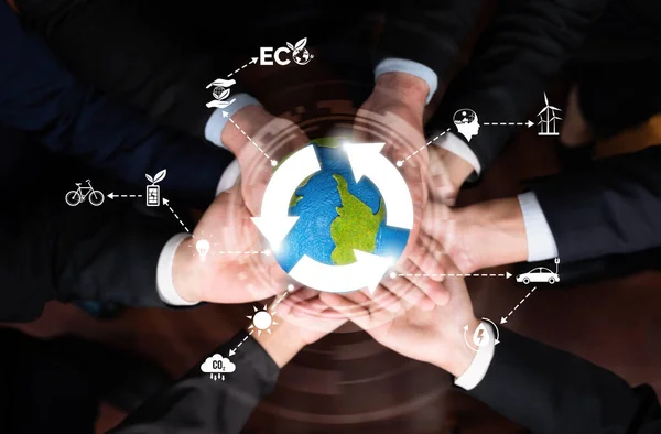 Business partnership holding Earth globe together with eco sustainability icon symbolize ESG sustainable environment and ecosystem protection with eco technology and carbon reduction. Reliance