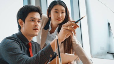 İki iş adamı toplantı odasında proje stratejisi hakkında konuşuyor. İş adamı, iş yerinde iş arkadaşlarıyla proje planlamasını tartışırken aynı zamanda mali raporla ilgili sohbet ve tavsiyelerde bulunuyor. Jivy