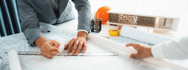 İşçi, mimar ve mühendis şehir alanının haritası ve kadastro haritası ile şehir planının inşaat geliştirici iş planına rehberlik etmek için emlak inşaatı hatiplik projesi hatiplik üzerinde çalışıyorlar.