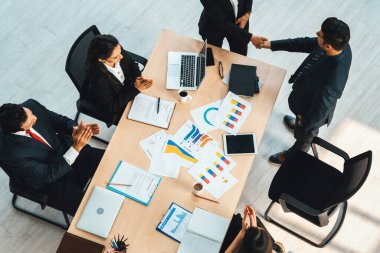 İş adamları grup toplantısı ofiste yukarıdan çekildi. İş kadınları, iş adamları ve ofis çalışanları toplantı masasında proje planlama belgeleriyle takım konferansında çalışıyorlar. Jivy