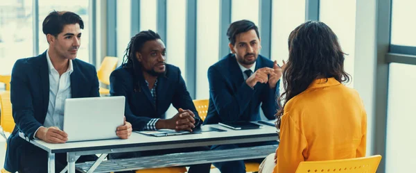Diversity recruiters interview candidate at the bright office. A group of human resources professionals explaining an applicant for a new position. asking interviewee a question. Intellectual.