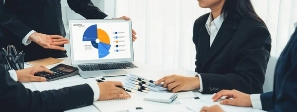 Business intelligence analyst team use BI software on laptop to analyze financial data dashboard. Business technology empower corporate executive to make strategic decision in panorama. Shrewd