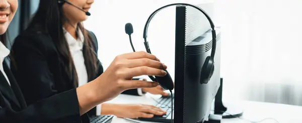 Business people wearing headset working in office to support remote customer or colleague. Call center, telemarketing, customer support agent provide service on telephone video conference oratory call