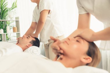 Kafkasyalı çift stres önleyici kafa masajının keyfini çıkarıyor ve lüks otellerde ya da otel spa salonlarında gündüz kaplıcalarında yüz güzelliği eğlencelerini şımartıyor. Sessiz.