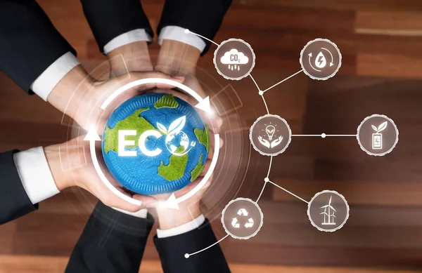 Business partnership holding Earth globe together with eco design icon symbolize ESG sustainable environment protection with eco technology and carbon credit solution for net zero ecosystem. Reliance