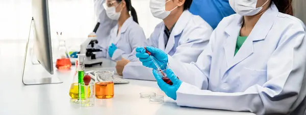 Laboratory researcher team advance healthcare with scientific expertise and laboratory equipment, researching new medicines and developing cure in the lab. Panorama Rigid