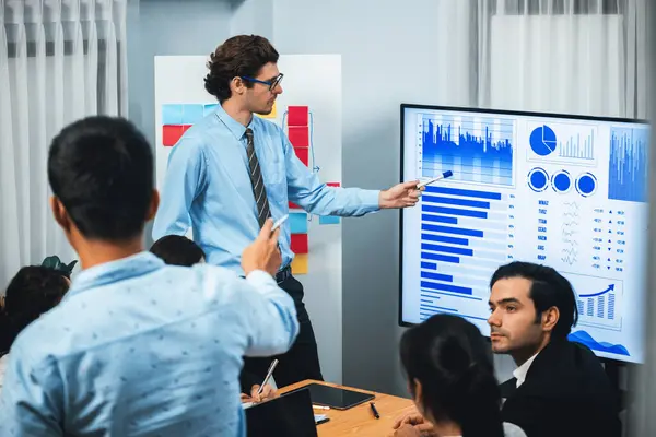 Businessman deliver business presentation with financial report data analysis or market trend show on big TV screen for strategic planing in meeting room for company future direction. Meticulous