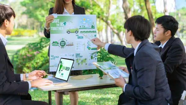Group of asian business people presenting environmentally friendly development plan and sustainable technology project for greener future, establishing outdoor eco business office at natural park.Gyre