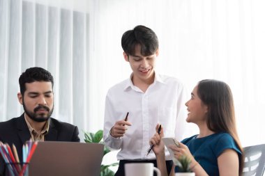 Profesyonel Asyalı çalışanlar, şirket ofisinde takım olarak çalışarak iş planları ve bilgisayarla başarılı olmak için verileri tartışırlar. Modern ofis çalışanı takım çalışması konsepti. Uyum