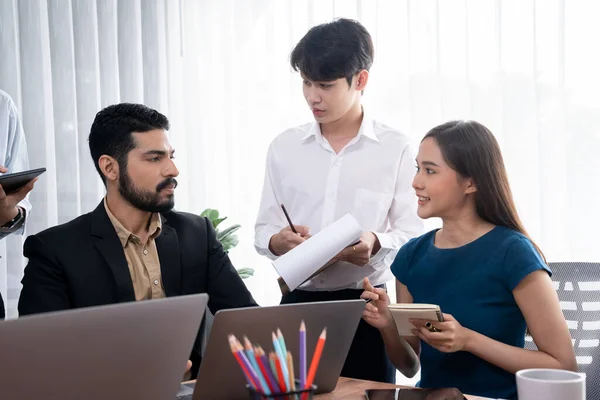 Professional Asian employee work together as team in corporate office, discussing business plans and data to achieve success on desk with laptop. Modern office worker teamwork concept. Concord