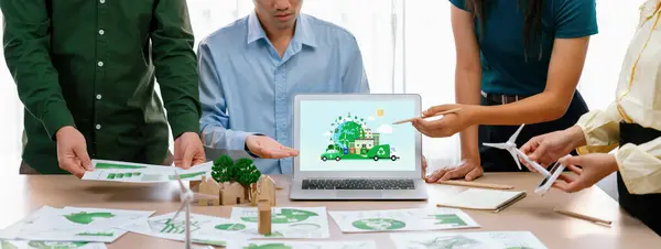 Green city and waste management illustrate displayed on laptop. Business team presenting green design to customer. ESG environment social governance and Eco conservative concept. Closeup. Delineation.