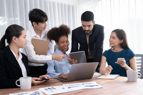 stock image Multiracial analyst team use BI dashboard data to analyze financial report on meeting table. Group of diverse business people utilize data analysis by FIntech for success business marketing. Concord