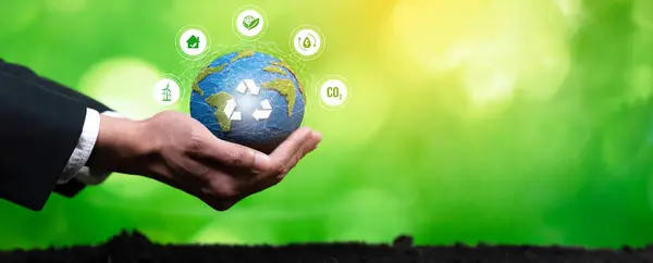 Businessperson holding and protecting Earth with recycle symbol. Business commitment to sustainable environmental protection and waste recycling practice for cleaner ecosystem. Panorama Reliance