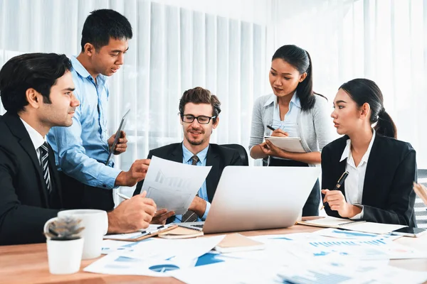 Diverse group of business analyst team analyzing financial data report paper on office table. Chart and graph dashboard by business intelligence analysis for strategic marketing planning Meticulous