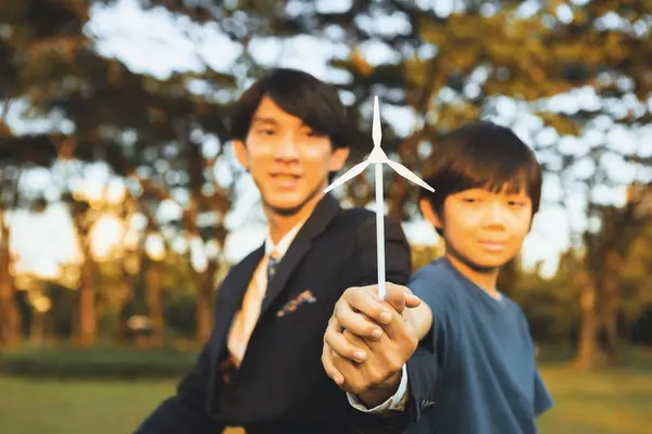 亚洲男孩和商人将风力涡轮机模型作为地球日的概念 作为企业的社会责任 使绿色和生态替代能源成为可持续的后代 — 图库照片