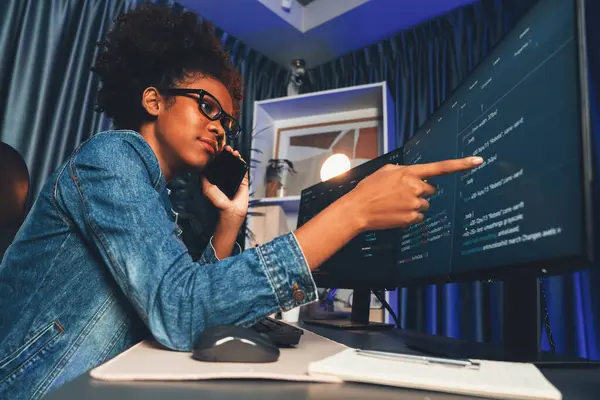Young African American IT developer concentrating on monitor screen laptop with codding program in data of application and website, Concept of creating innovative html updated version. Tastemaker.