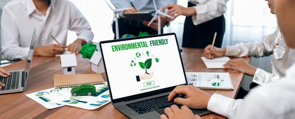 Business people in green corporate company planning eco-friendly and environmental conservative to reduce CO2 and implement net zero policy in meeting room with eco idea on laptop screen. Trailblazing