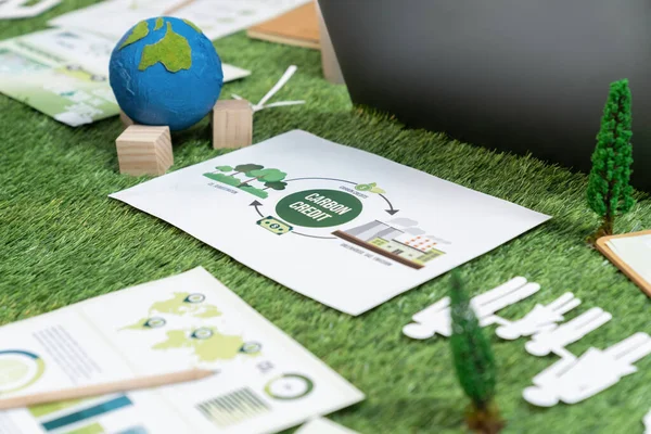 Stock image Corporate business company plan and research paper on reducing CO2 emission and carbon credit by renewable clean energy technology utilization on meeting table as hub of eco innovative idea. Quaint