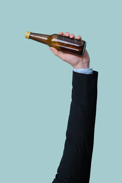 Businessmans hand holding glass bottle on isolated background. Eco-business recycle waste policy in corporate responsibility. Reuse, reduce and recycle for sustainability environment. Quaint