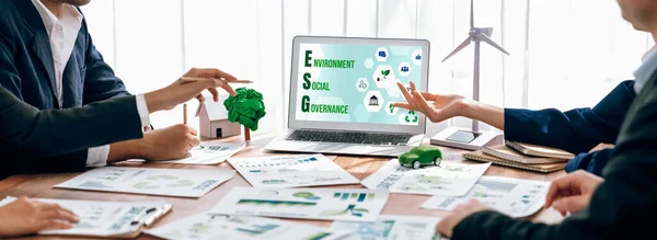 ESG environmental social governance display on laptop on eco-friendly company meeting with business people implementing environmental protection for clean and sustainable future ecology. Trailblazing