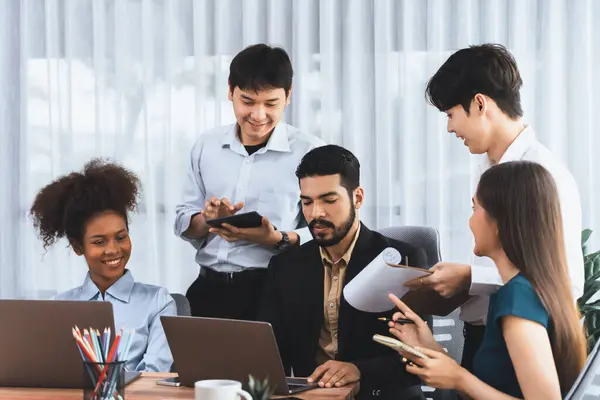 stock image Happy diverse business people work together, discussing in corporate office. Professional and diversity teamwork discuss business plan on desk with laptop. Modern multicultural office worker. Concord