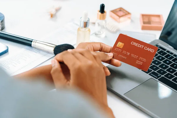 Close up credit card using for online payment, banking and shopping on the internet network with laptop computer showing credit card technology for online secured wallet top up and crucial purchase