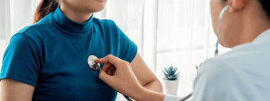 Hasta klinikte ya da hastane ofisinde doktor randevusuna gidiyor. Hastaların nabzını steteskopla kontrol ederken, doktor semptomları muayene ediyor ve teşhis ediyor. Panorama Katı