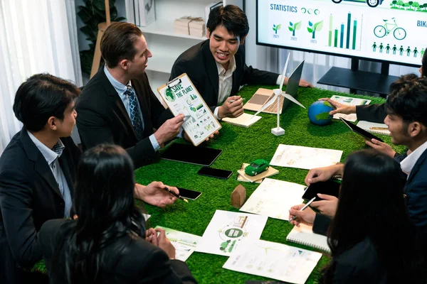 Diverse group of business people planning business marketing investment with eco-friendly policy for greener ecology. Productive teamwork contribute natural preservation and sustainable future. Quaint