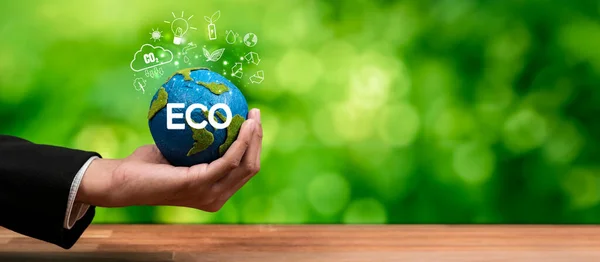 Businessmans hand holding Earth globe symbolize corporate commitment to ESG to reduce carbon emission, adopt eco friendly business to minimize environment impact for net zero world. Panorama Reliance